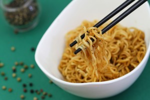 Chinese noodles on chopsticks, closeup